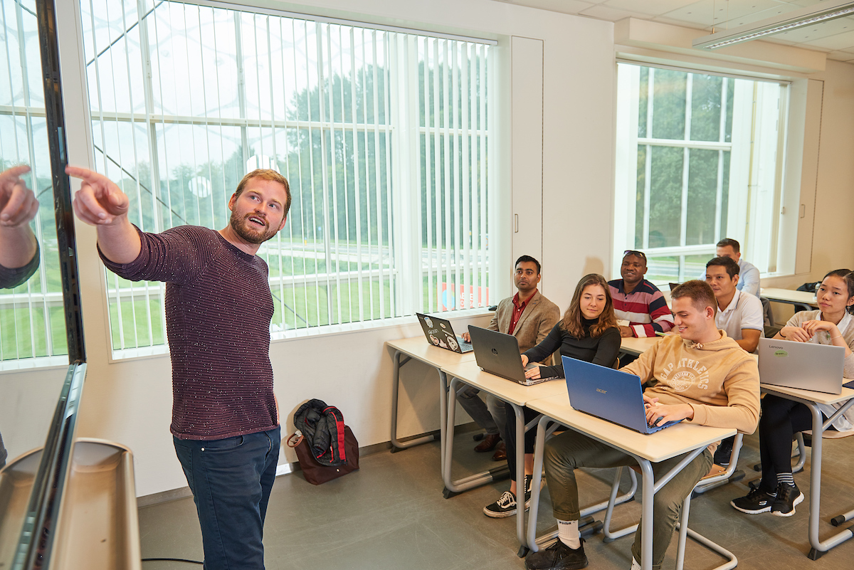 Students listen to teacher in classroom